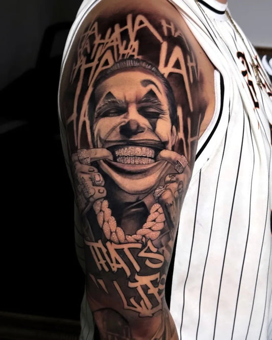 Big Black and Grey Joker with Laughing Text on Men Arm Tattoo by @dalby.ink