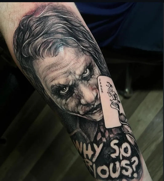 Big Black and Grey Joker with Playing Card and Why So Serious on Men Arm Tattoo by @abyssartstudiolbny
