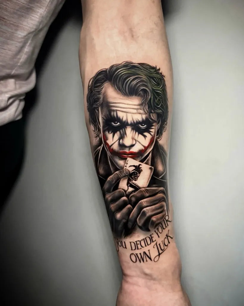 Big Black and Grey Joker with Playing Card on Men Arm Tattoo by @laura_marzal_tattoo
