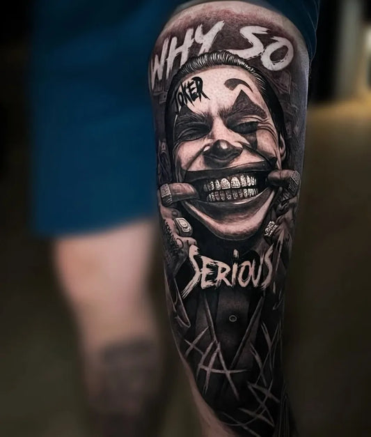 Big Black and Grey Joker with Text on Men Thigh Tattoo by @goonsandqueens_enschede