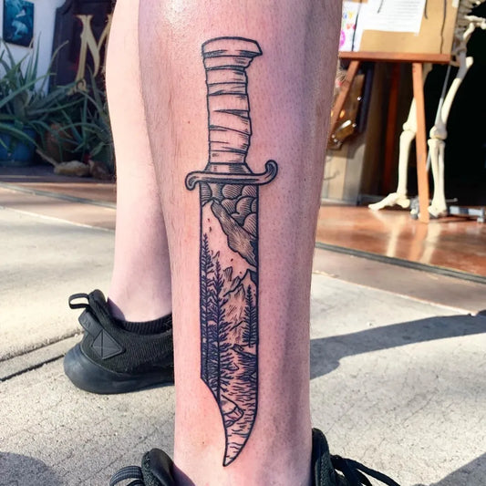 Big Black and Grey Knife with Mountains Tattoo on Men Leg by @e.griffin_tattooer