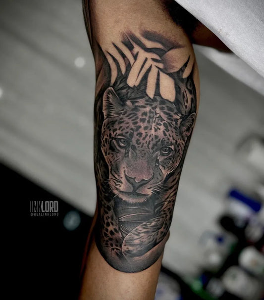 Big Black and Grey Leopard with Palm Leaves Tattoo on Men Inner Arm by @realinklord