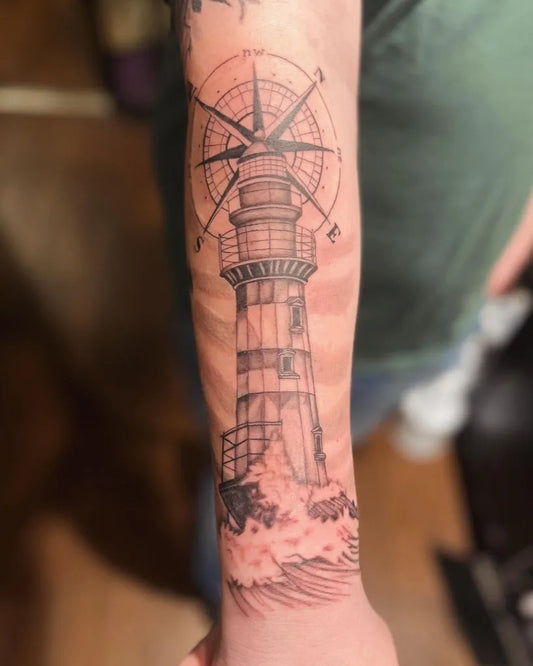 Big Black and Grey Lighthouse and Compass Tattoo on Men Arm by @gt_inks