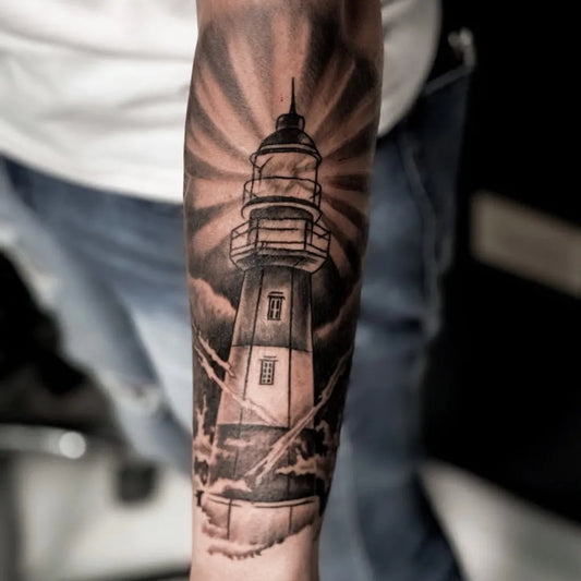 Big Black and Grey Lighthouse with Rays Tattoo on Men Arm by @chelomanosanta