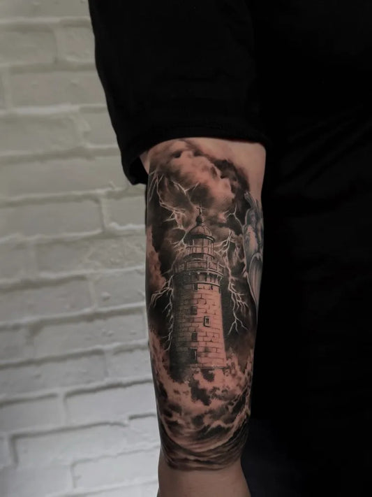 Big Black and Grey Lighthouse with Storm Clouds Tattoo on Men Arm by @eni.ink_
