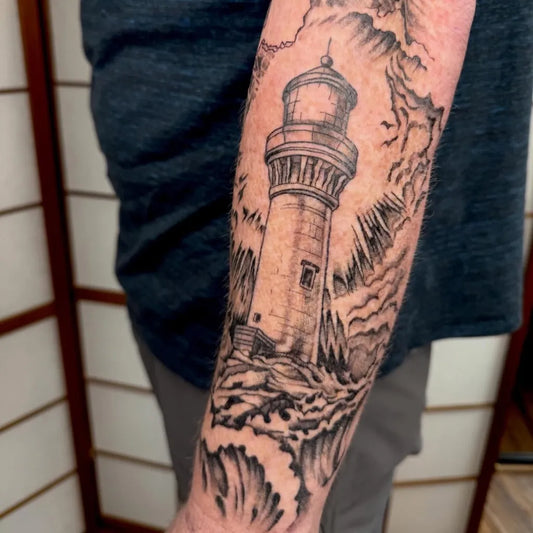 Big Black and Grey Lighthouse with Storm and Waves Tattoo on Men Arm by @ekellytattoos