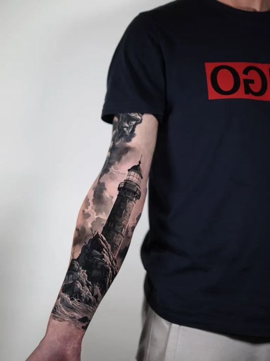 Big Black and Grey Lighthouse with Stormy Ocean Tattoo on Men Arm by @joeyboontattooartist