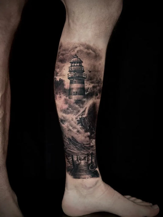 Big Black and Grey Lighthouse with Stormy Waves Tattoo on Men Leg by @krisbarnastattoo