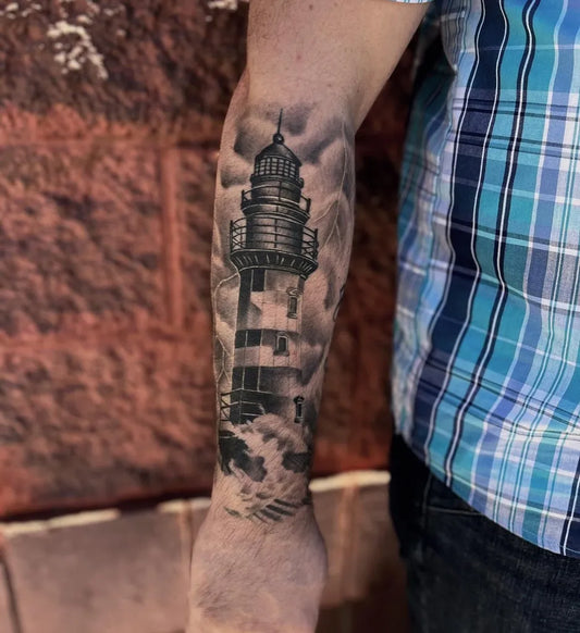 Big Black and Grey Lighthouse with Waves Tattoo on Men Arm by @_aaroncarey