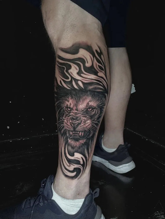Big Black and Grey Lion Tribal Flames on Men Leg Tattoo by @tashajadelambert