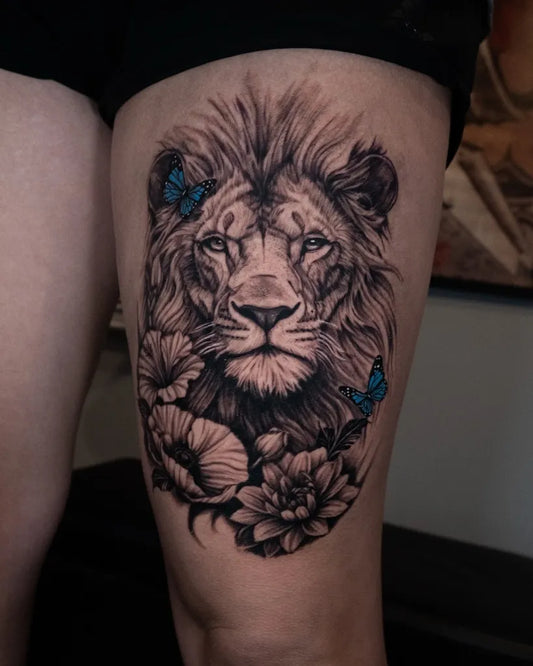 Big Black and Grey Lion with Flowers and Butterflies on Women Thigh Tattoo by @orpheustattoo