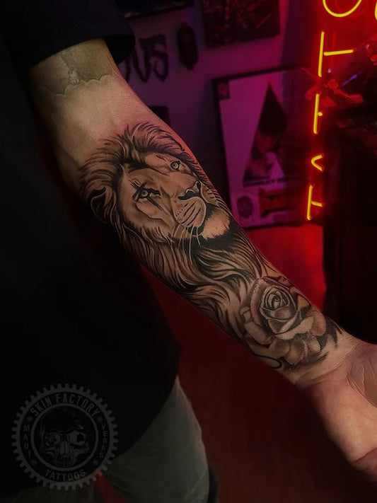 Big Black and Grey Lion with Rose on Men Arm Tattoo by @skinfactorylv