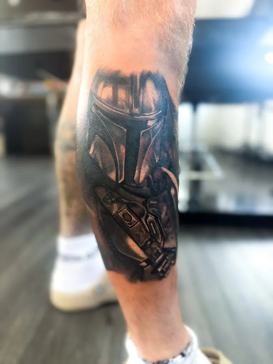 Big Black and Grey Mandalorian Helmet Star Wars Tattoo on Men Thigh by @kaiyotattoo