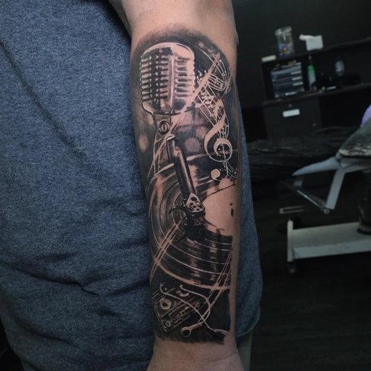 Big Black and Grey Microphone Turntable Notes Music Tattoo on Men Arm by @tatts_by_viq