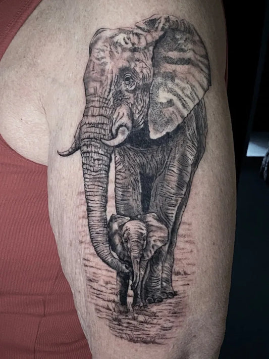 Big Black and Grey Mother Elephant with Baby Tattoo on Women Shoulder by @wattmilli