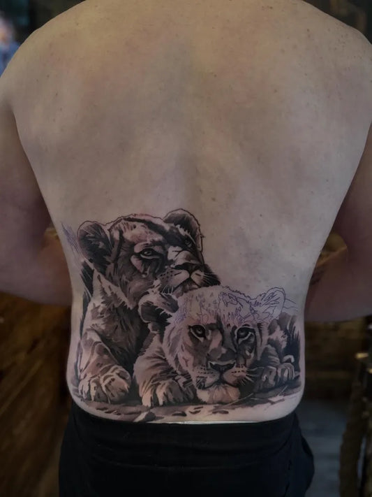 Big Black and Grey Mother Lion and Cub on Men Back Tattoo by @leesailormerry