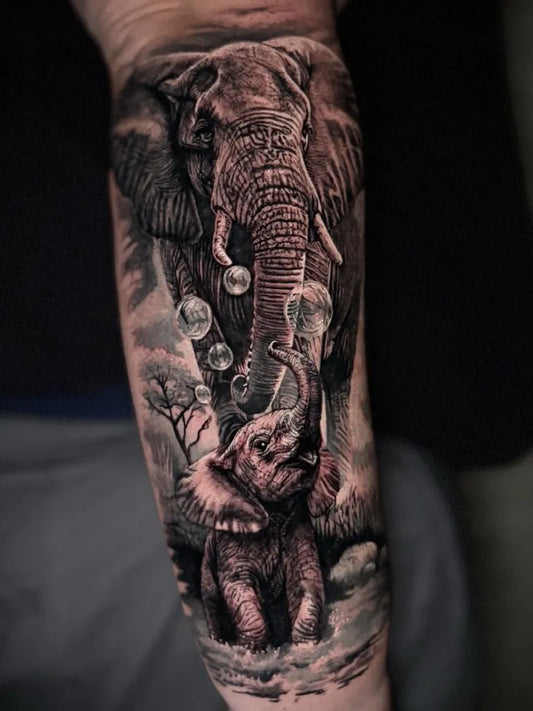 Big Black and Grey Mother and Baby Elephant Tattoo on Men Arm by @mat.tattoo_artist