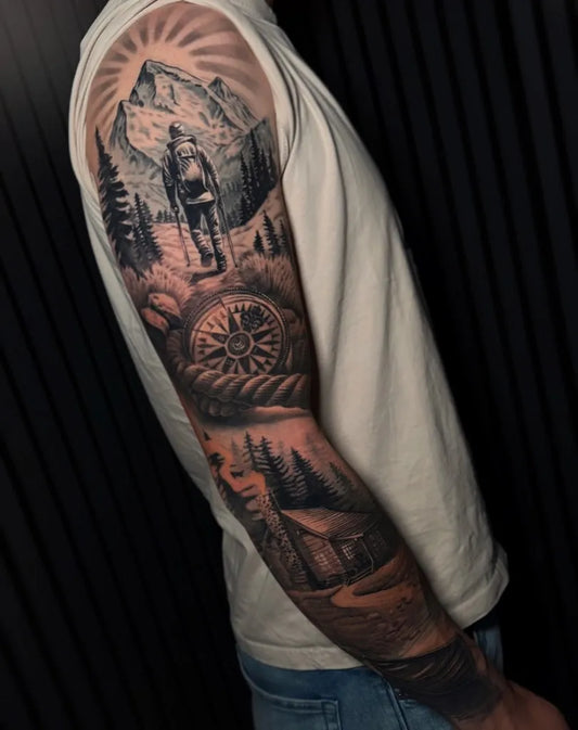 Big Black and Grey Mountain Hiker Compass Cabin Tattoo on Men Arm by @crazybodyarttattoo