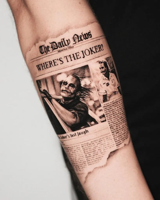 Big Black and Grey Newspaper with Joker on Men Arm Tattoo by @kidneedle_tattoo