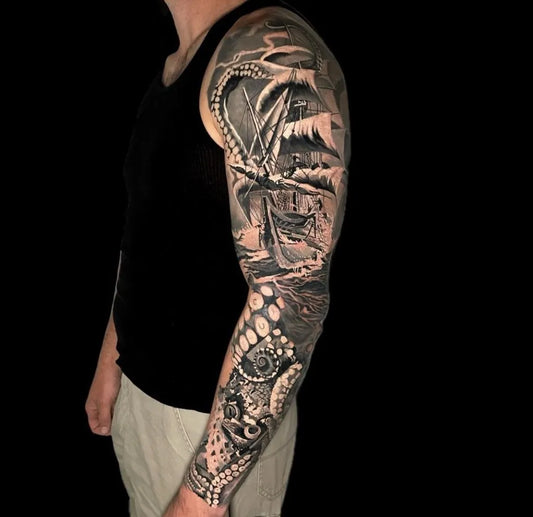 Big Black and Grey Octopus Ship Tattoo on Men Arm by @exodustattoostudiosnewyork