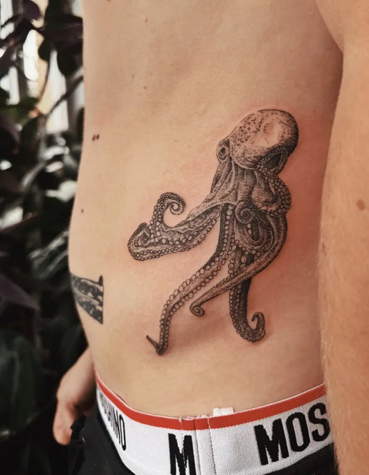 Big Black and Grey Octopus Tattoo on Men Rib by @nature_obscure