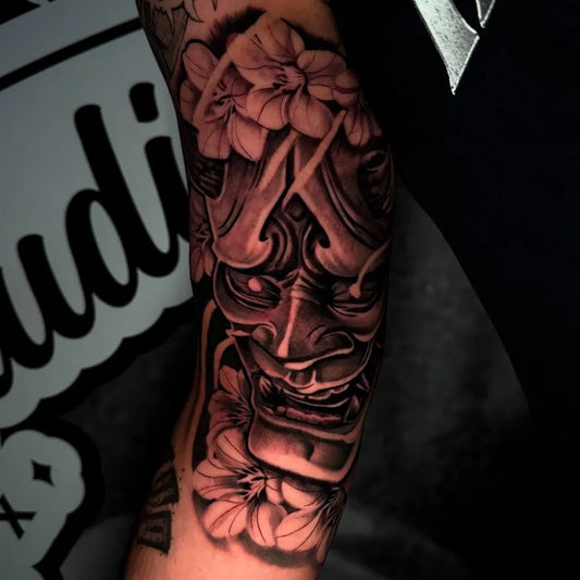 Big Black and Grey Oni Mask with Flowers on Men Arm Tattoo by @ortiz.tattoos