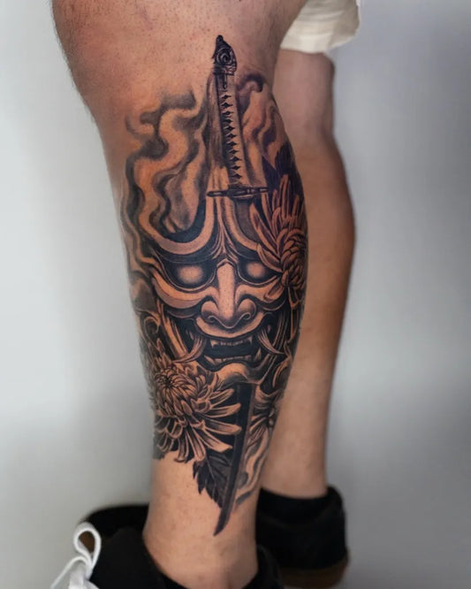 Big Black and Grey Oni Mask with Sword and Chrysanthemum on Men Leg Tattoo by @danielcuevas.ink
