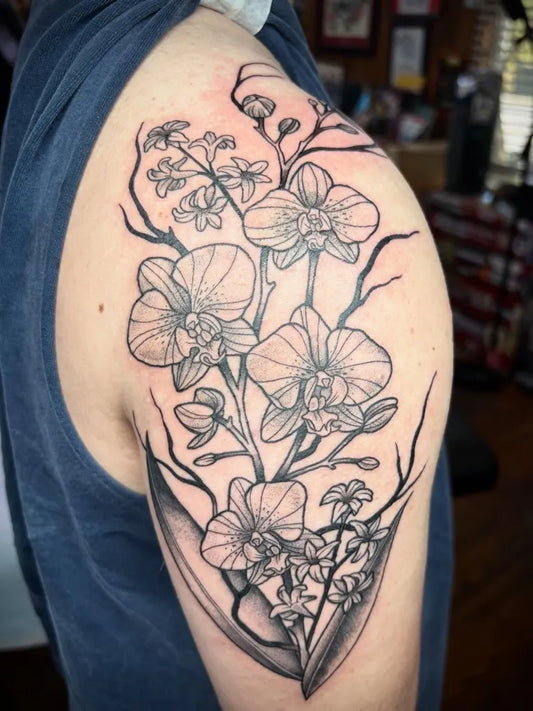 Big Black and Grey Orchid and Branches Tattoo on Men Shoulder by @harmo.ink