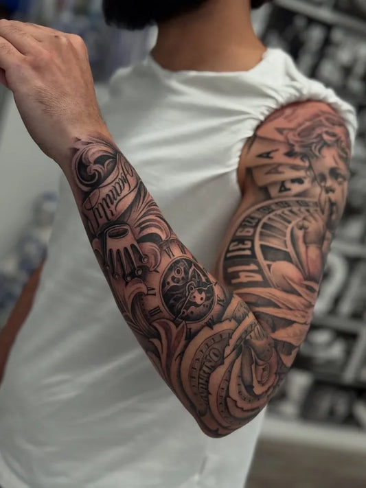 Big Black and Grey Ornate Sleeve with Cherub and Clock Tattoo on Men Arm by @inkbyry