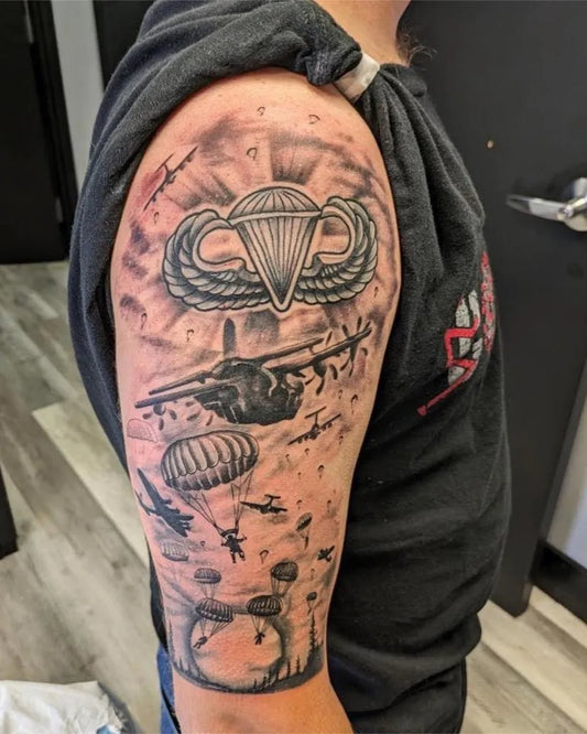 Big Black and Grey Paratrooper Wings and Parachute Drop Military Tattoo on Men Arm by @americantattoosociety