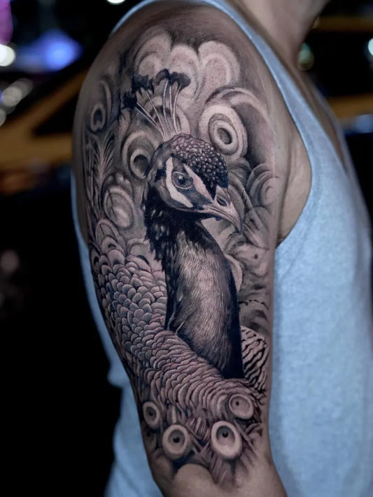 Big Black and Grey Peacock Tattoo on Men Upper Arm by @ziaboyd