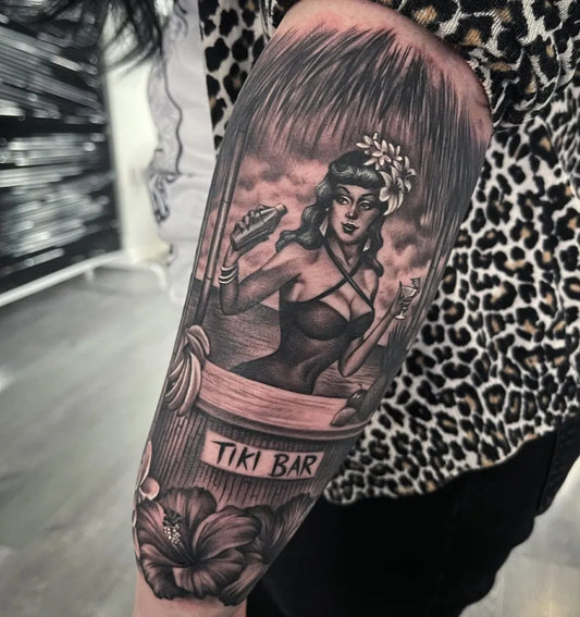 Big Black and Grey Pin Up Girl Tiki Bar Tattoo on Women Arm by @bethanyriverstattoos
