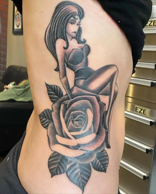 Big Black and Grey Pin Up Girl with Rose Tattoo on Women Side by @hanger18tattoos
