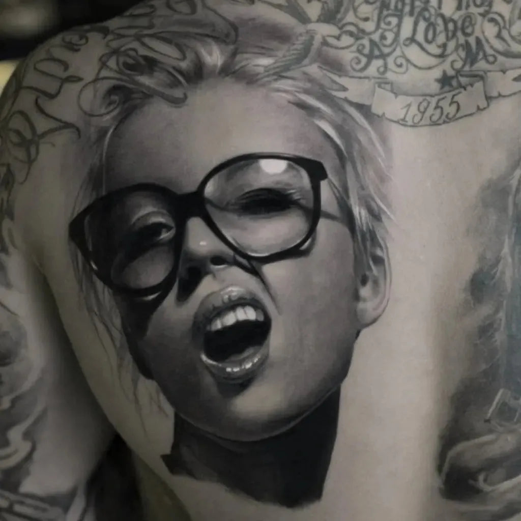 Big Black and Grey Portrait of Woman with Glasses and Open Mouth Tattoo on Men Back by @killerinktattoo