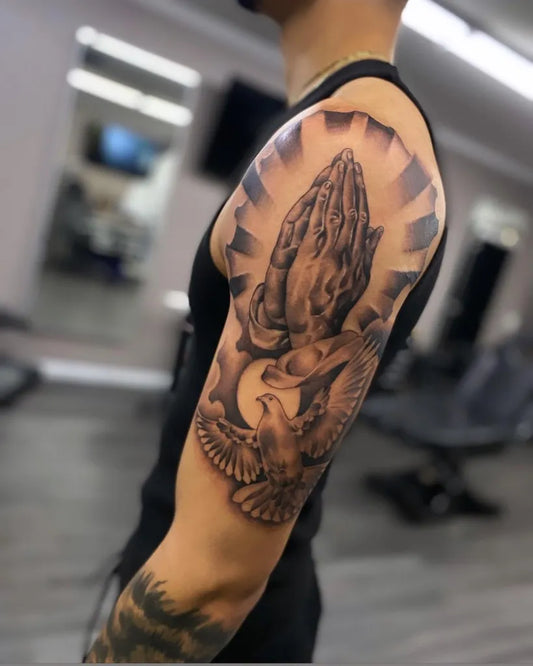 Big Black and Grey Praying Hands Dove and Rays Tattoo on Men Upper Arm by @tatts_by_ant