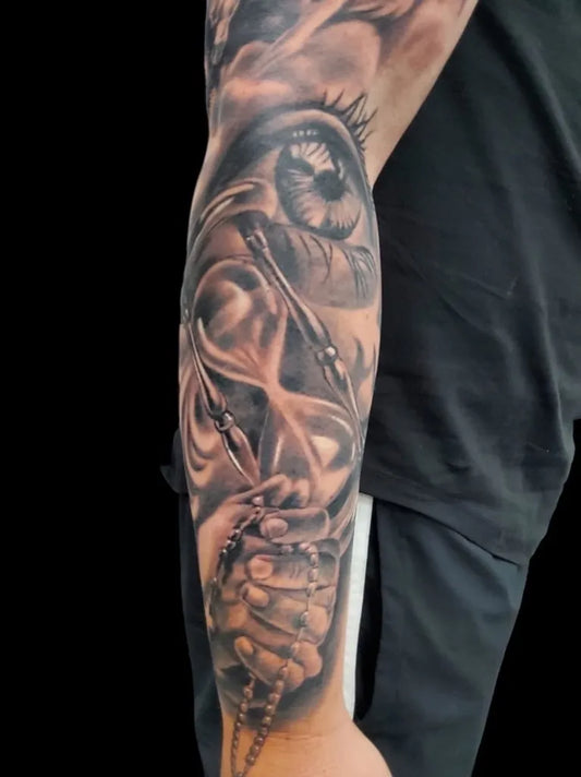 Big Black and Grey Praying Hands Hourglass Eye Tattoo on Men Arm by @primitivetattoo