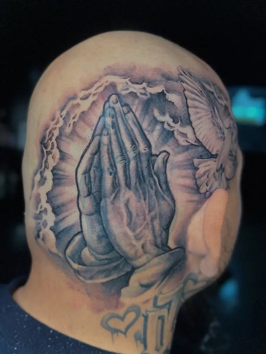 Big Black and Grey Praying Hands with Dove and Rays Tattoo on Men Head by @mommasboy_tattoo