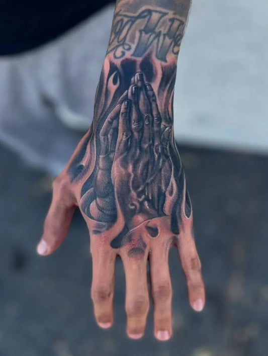 Big Black and Grey Praying Hands with Flames Tattoo on Men Hand by @freshink_tat2