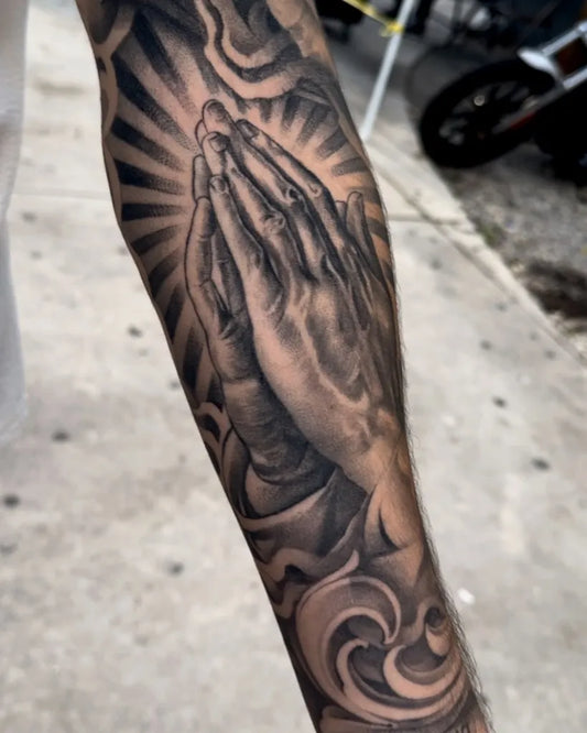 Big Black and Grey Praying Hands with Rays and Clouds Tattoo on Men Arm by @adtattoos