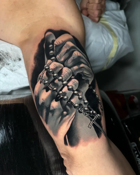 Big Black and Grey Praying Hands with Rosary Tattoo on Men Arm by @atelier.penumbre