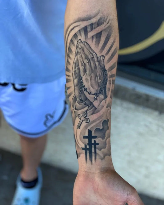 Big Black and Grey Praying Hands with Rosary and Crosses Tattoo on Men Arm by @tatts_by_ant