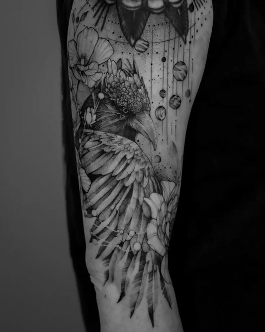 Big Black and Grey Raven with Flowers and Celestial Motifs on Men Arm Tattoo by @vault.tat