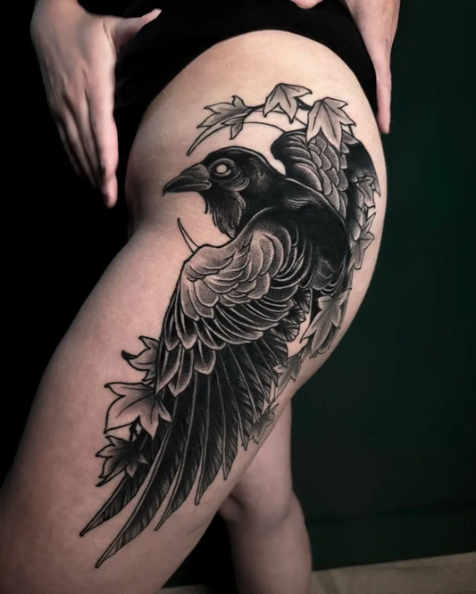 Big Black and Grey Raven with Ivy and Lilies on Women Thigh Tattoo by @yesitattoos