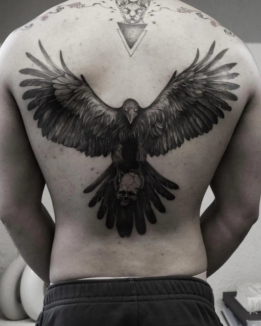 Big Black and Grey Raven with Skull on Men Back Tattoo by @zk.ink