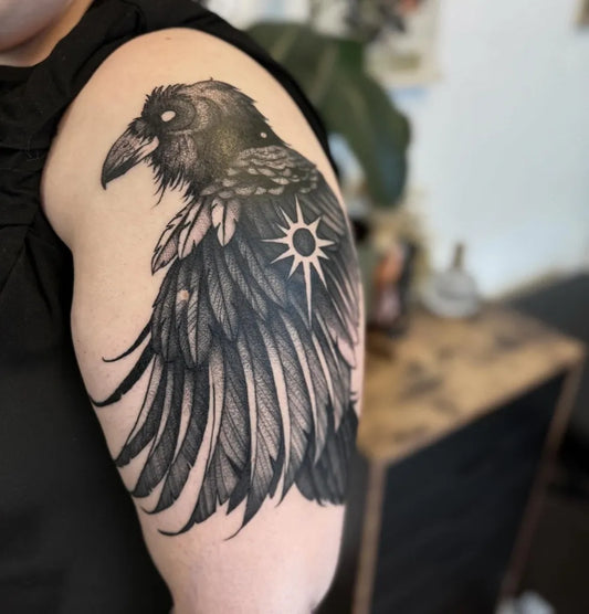 Big Black and Grey Raven with Sunburst on Women Arm Tattoo by @littleferntattoo