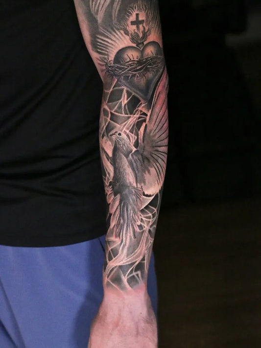 Big Black and Grey Sacred Heart Dove Tattoo on Men Arm by @yukstattoos
