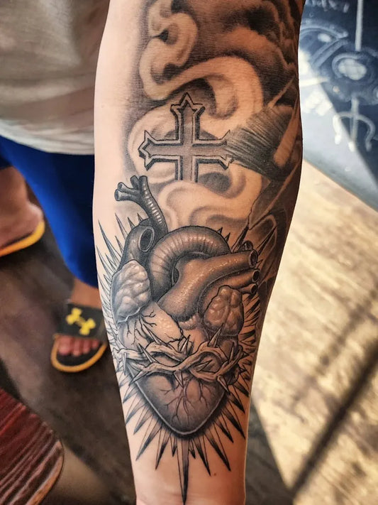 Big Black and Grey Sacred Heart with Cross and Brush Tattoo on Men Arm by @ower_hernandez