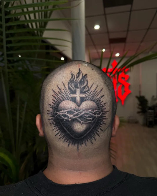 Big Black and Grey Sacred Heart with Crown of Thorns and Radiating Rays Tattoo on Men Head by @artedepreciado