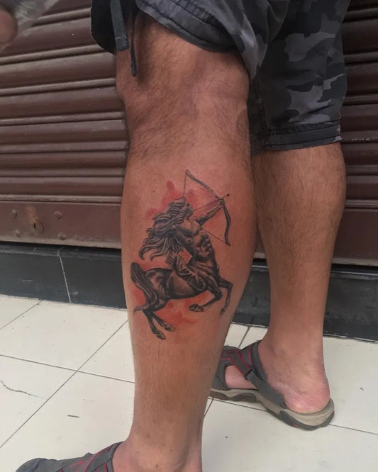 Big Black and Grey Sagittarius Archer on Horse Tattoo on Men Leg by @naughtyneedlestattoos