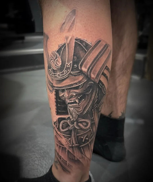 Big Black and Grey Samurai Mask Tattoo on Men Leg by @shan_zooztattoo